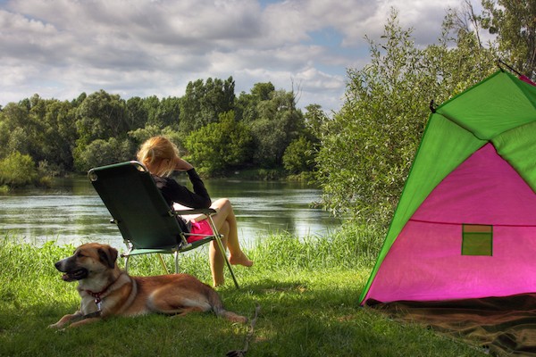 A dog and a person camping. 