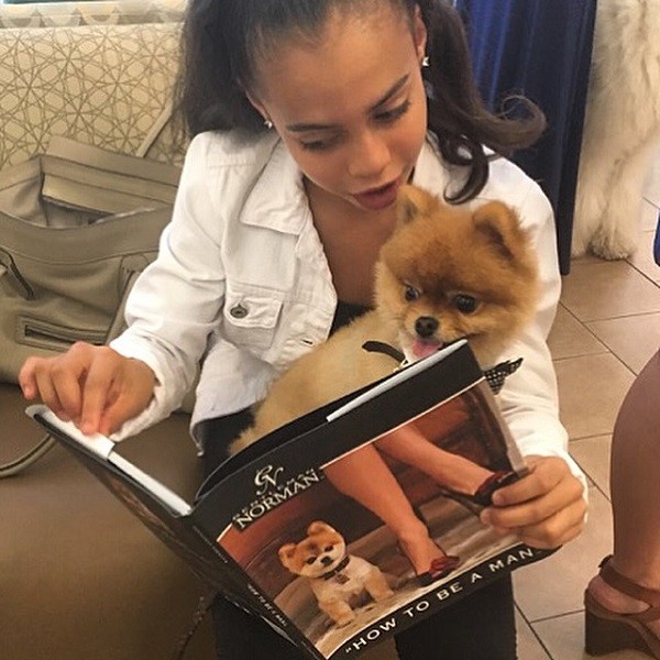 Asia Monet reads to one of her favorite pups Norman, from Norman's own book, How to Be a Man. (Photo by ___) 