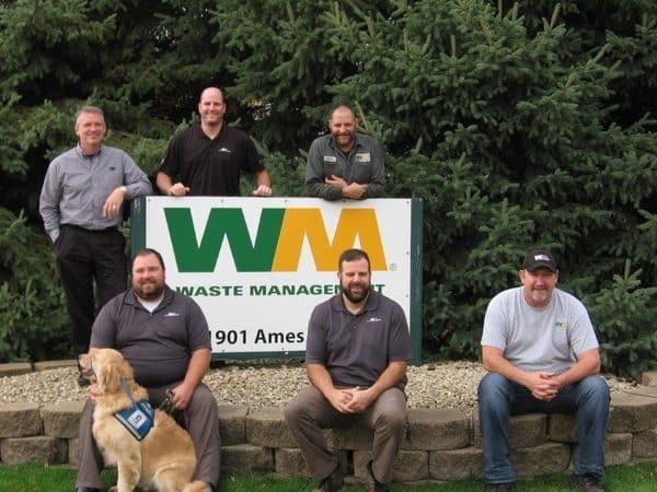 Carl and Jed pose with some colleagues at work. (Photo courtesy Waste Management)