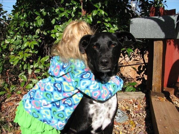 Riggins and his human cousin, Kira. One of the only children he will tolerate. (Photo by Wendy Newell)