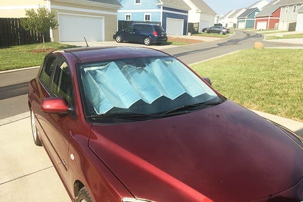 To help keep heat out, put a reflective sunshade on the interior of your front window.