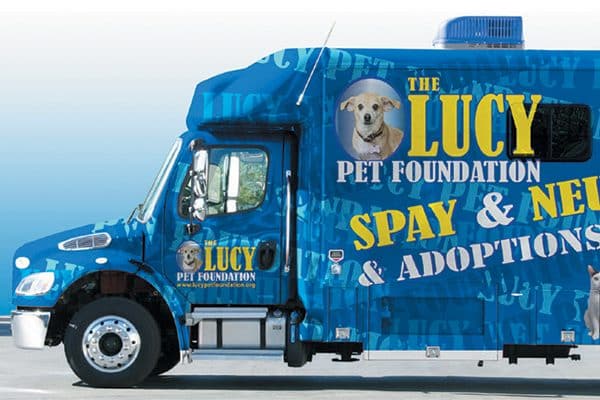 The Lucy Pet Foundation mobile truck with dogs pictured on the side on the truck.
