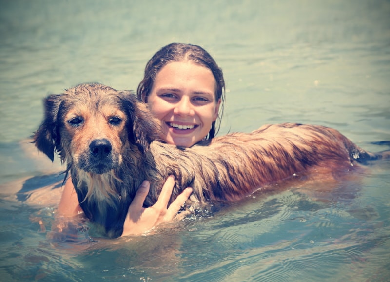 dog owner swimming with her dog
