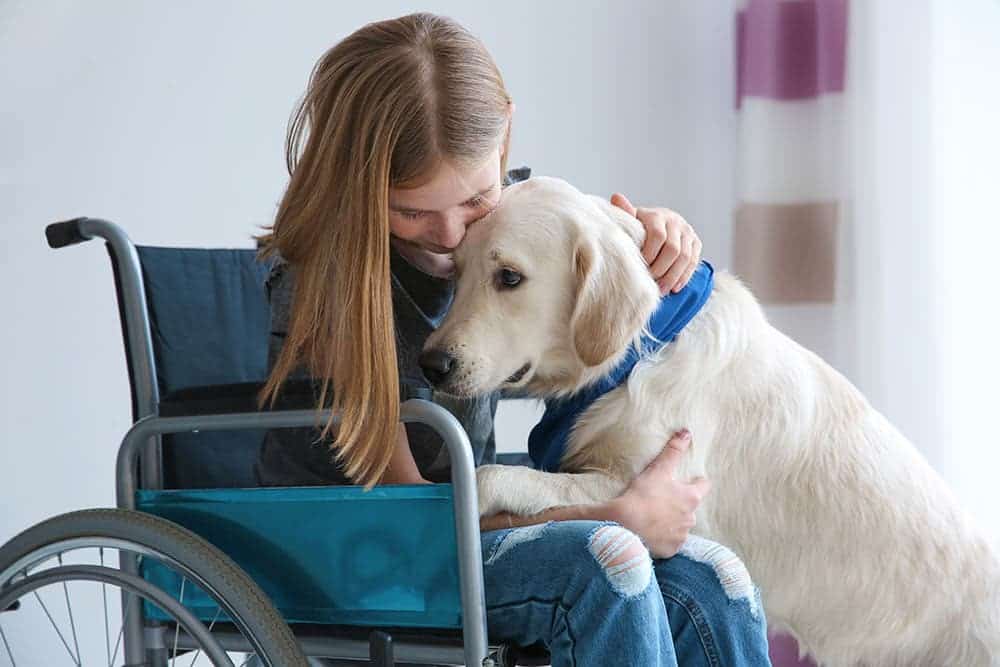 girl hugging her pyschiatric service dog