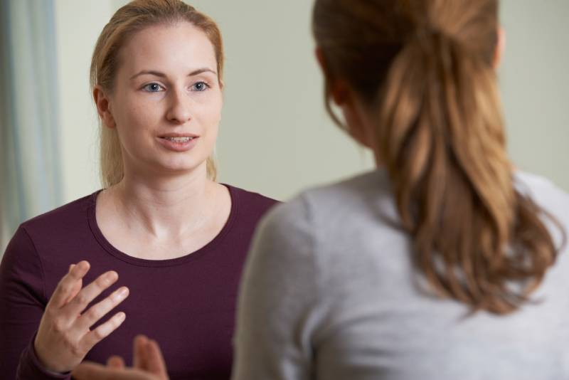 two woman discussing