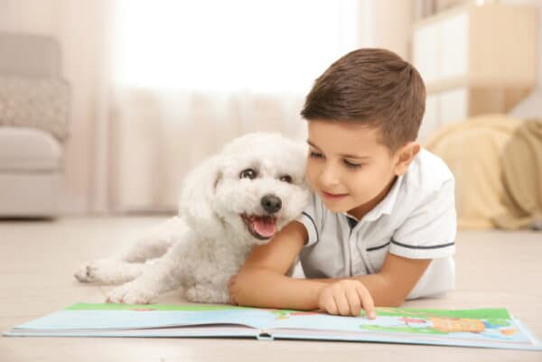 little boy and dog reading book