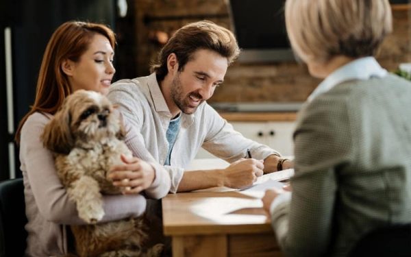 a-couple-with-pet-signing-insurance-contract