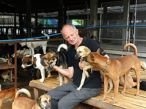 Soi Dog co-founder John Dalley with rescue dogs at the foundation's shelter in Phuket, Thailand.