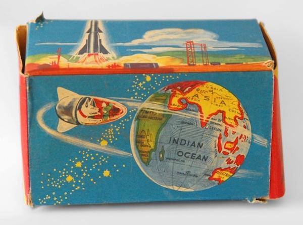 Toy packaging with Laika's image on it, happily orbiting the earth.