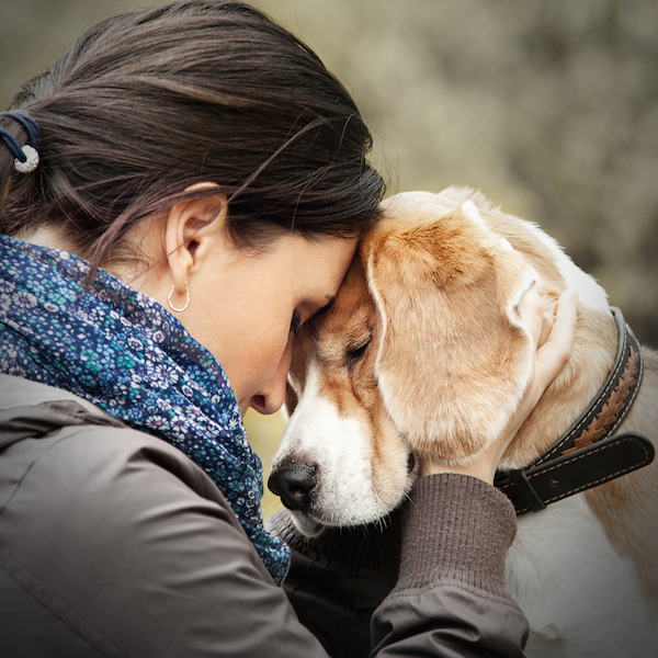 Woman with dog by Shutterstock.