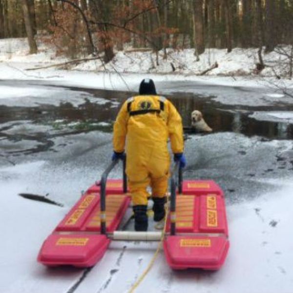 Sudbury, Mass., firemen deploy a special ice-rescue sled to save Satchel from freezing waters. (Photo courtesy of the Sudbury Fire Department)