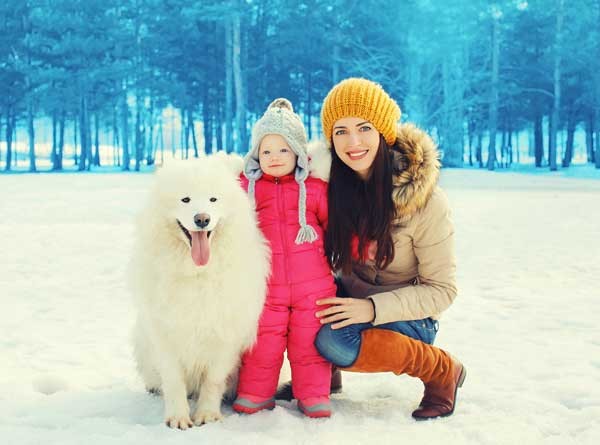 Family in snow by Shutterstock
