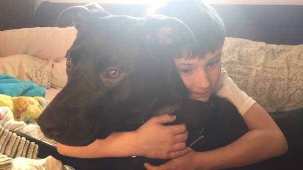 Justin hugging Magnum, they're growing up together. Photo by Zinnia Willingham.