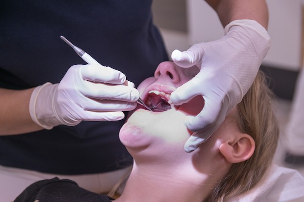 Woman at dentist's office by Shutterstock.