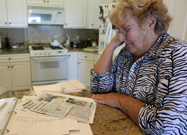 Sherry Schneider looks through a scrap book the family started documenting their adoption of Jasmine.