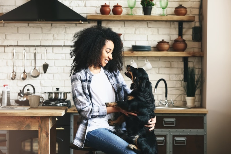 woman with her dog in the kitchen