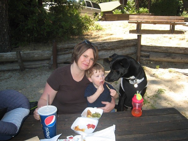 Riggins tries to find a way to steal my nephew's fries while my sister is busy smiling for the camera. (Photo by Wendy Newell)