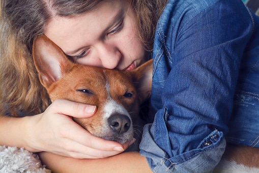 girl hugging dog what to expect when your dog has cancer
