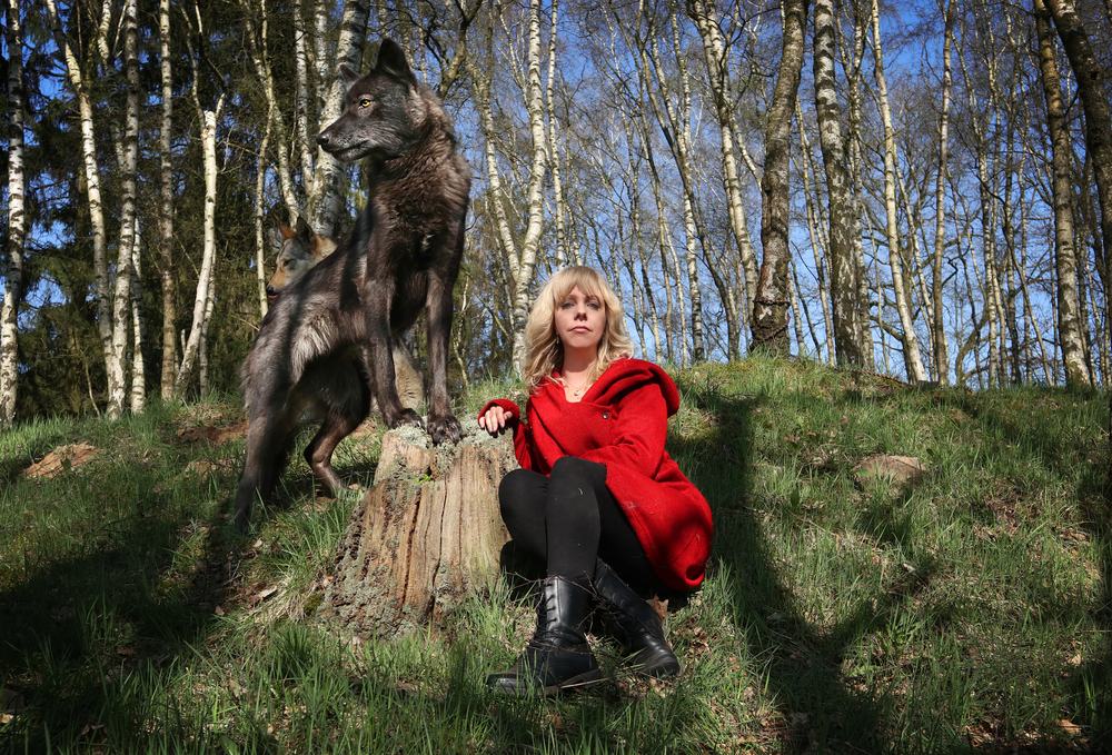 Woman and wolfdog in the forest