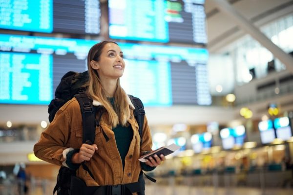 Woman at the airport hollding phone