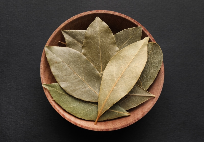 Bay leaves in wooden bowl