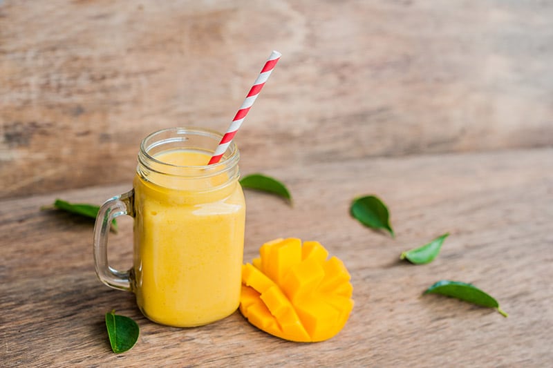 a glass of mango smoothie