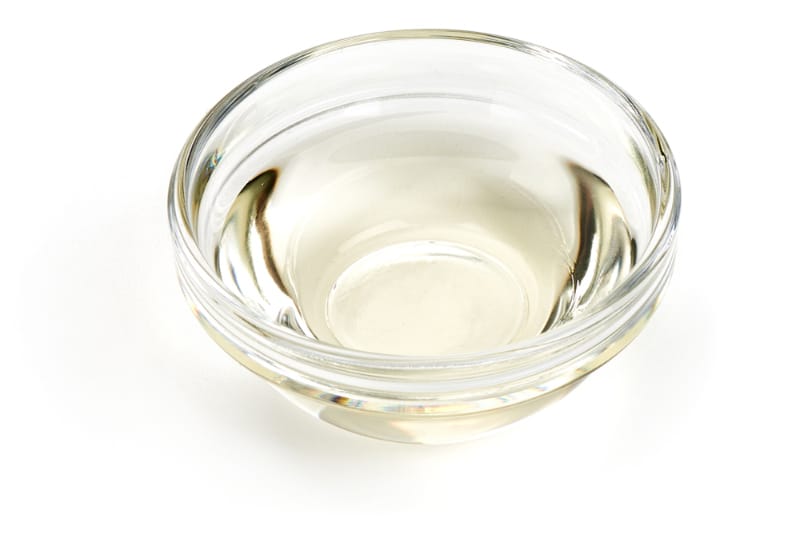 a glass of white vinegar