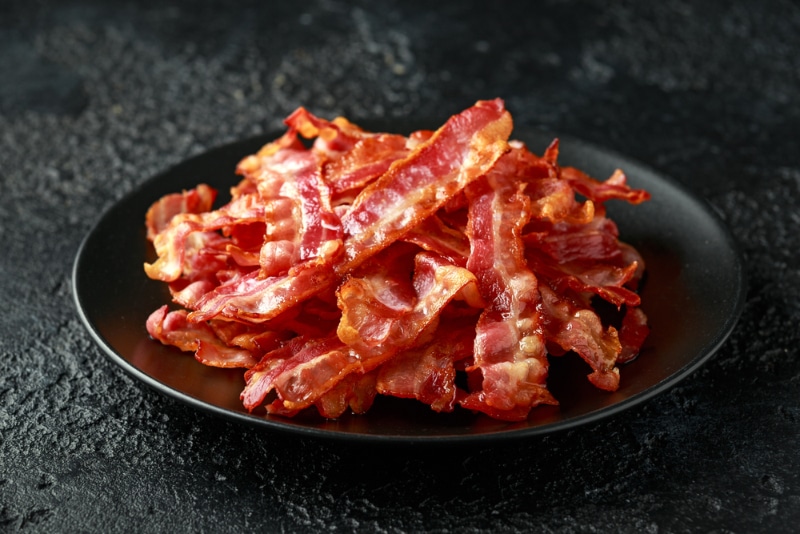 a plate of fried bacon