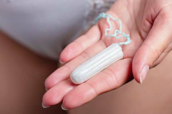 girl holding menstruation tampon on hand