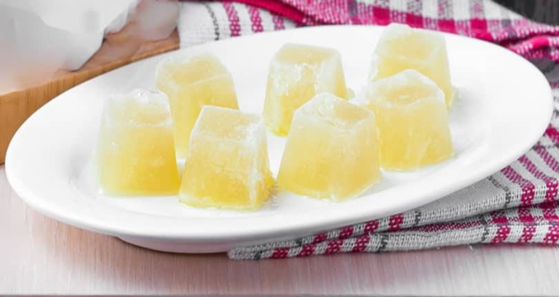 homemade frozen chicken vegetable broth ice cubes on a plate