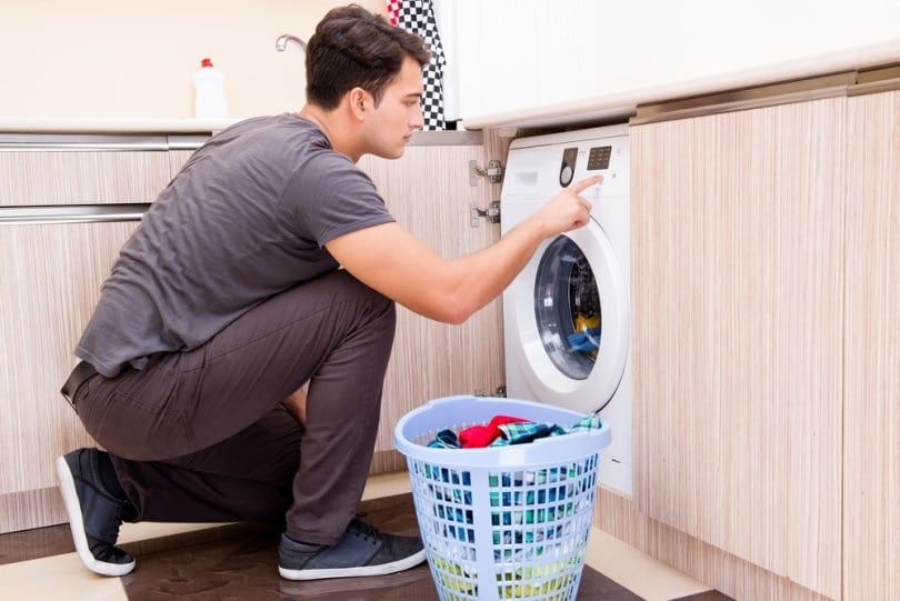 man using washing machine