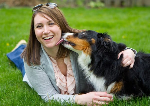 Dog licking woman's face