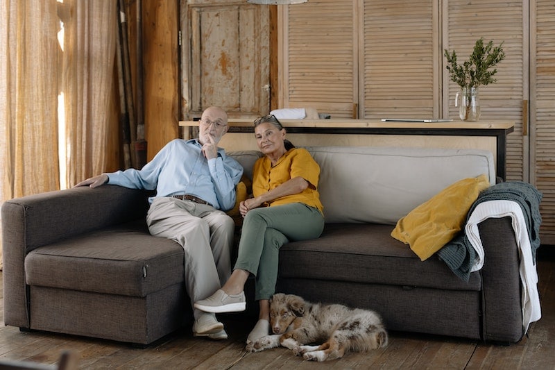 Australian Shepherd leaning on woman's feet