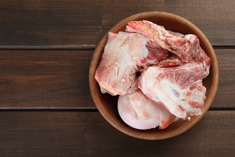 Bowl with raw chopped meaty bones