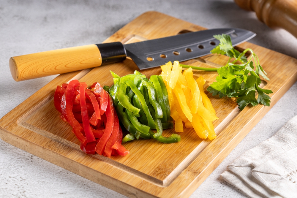 Colorful bell peppers sliced ​​on cutting board