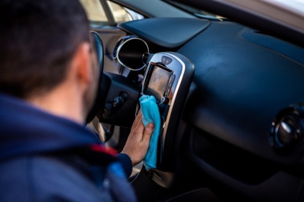 Man cleaning car interior