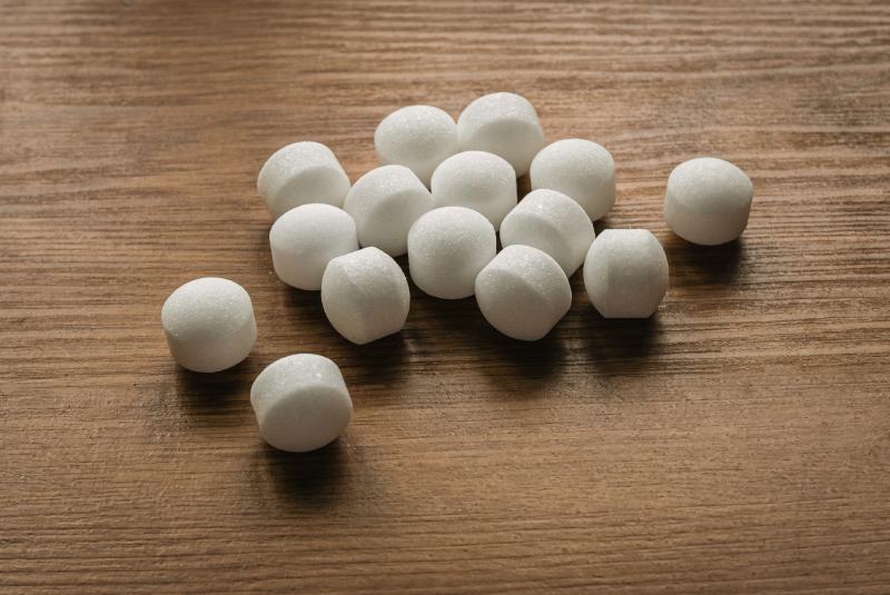 Naphthalene mothballs on wooden background