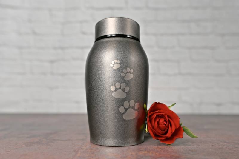 Pet urn beside a red rose