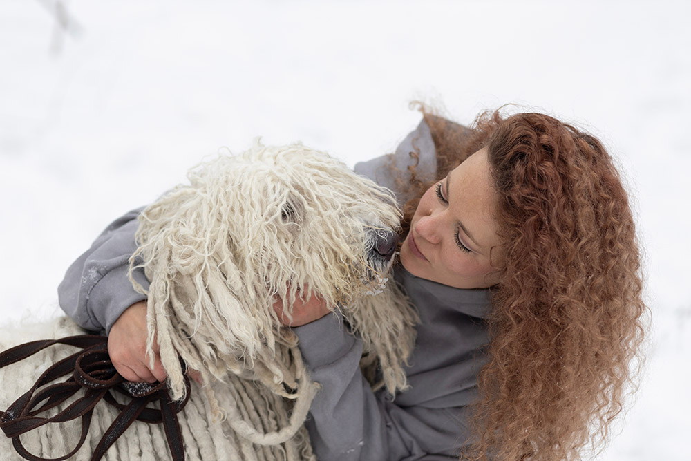 Portrait of a beautiful girl with a dog Komondor