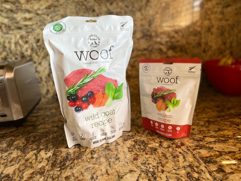 The New Zealand Natural Pet Food Co. Freeze Dried Food and Air Dried Dog Bites - the products on the counter