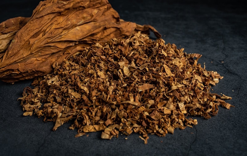 Tobacco leaves and cut tobacco on the table