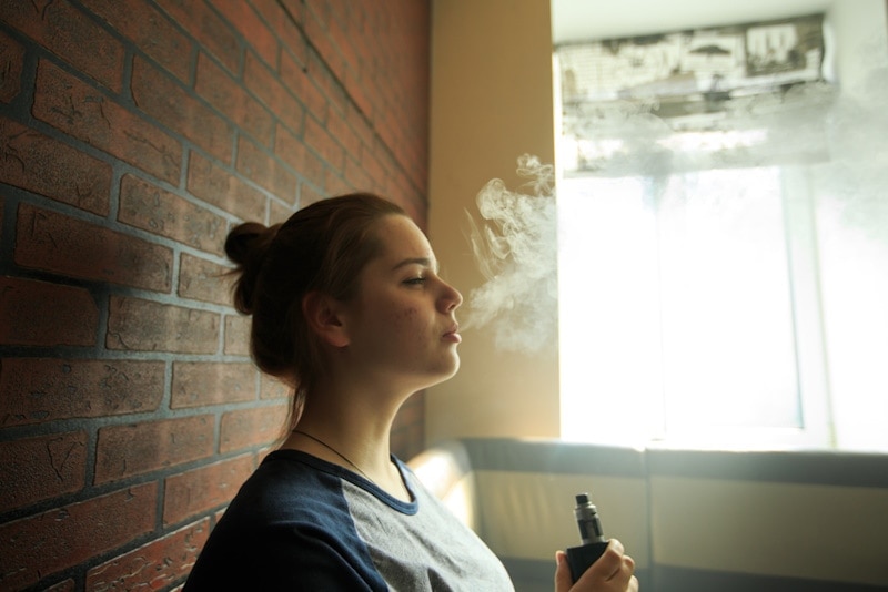 Woman vaping indoors