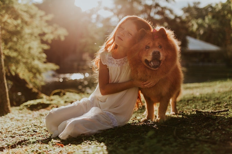 Young girl with her dog in the garden
