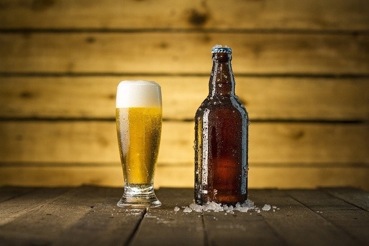 a cold glass and bottle of beer