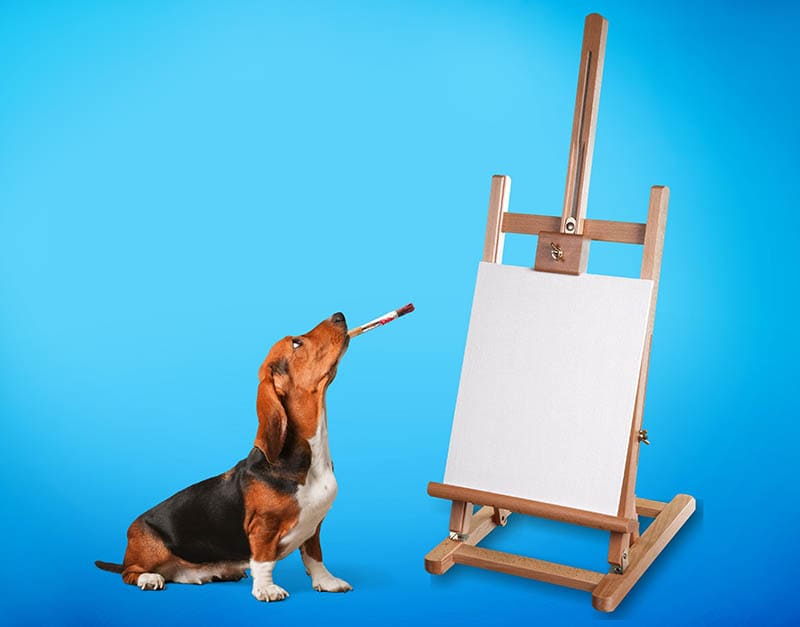 beagle dog holding a paint brush in its mouth and an easel on the side