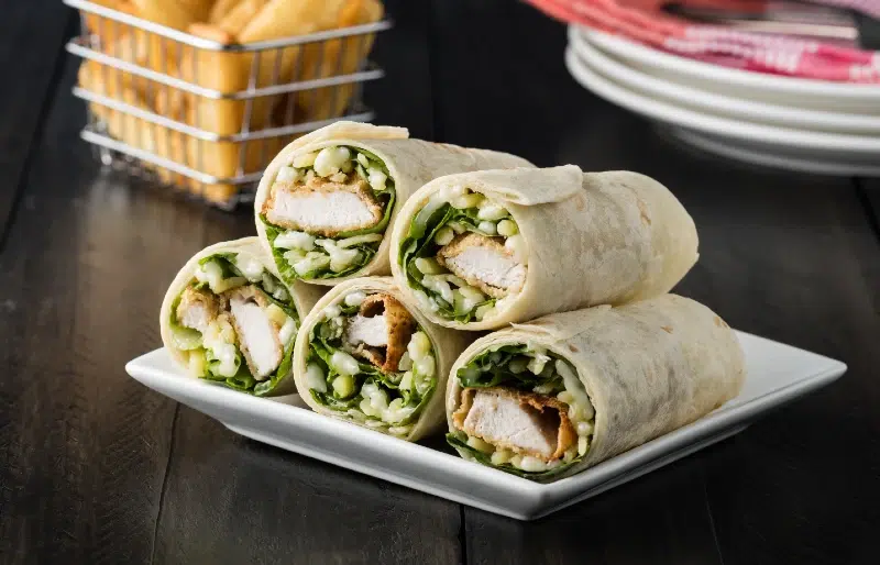 chicken burrito wrap with french fries in the background