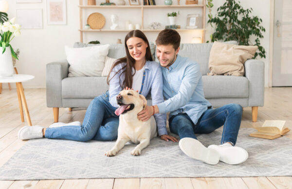 couple patting a dog at home