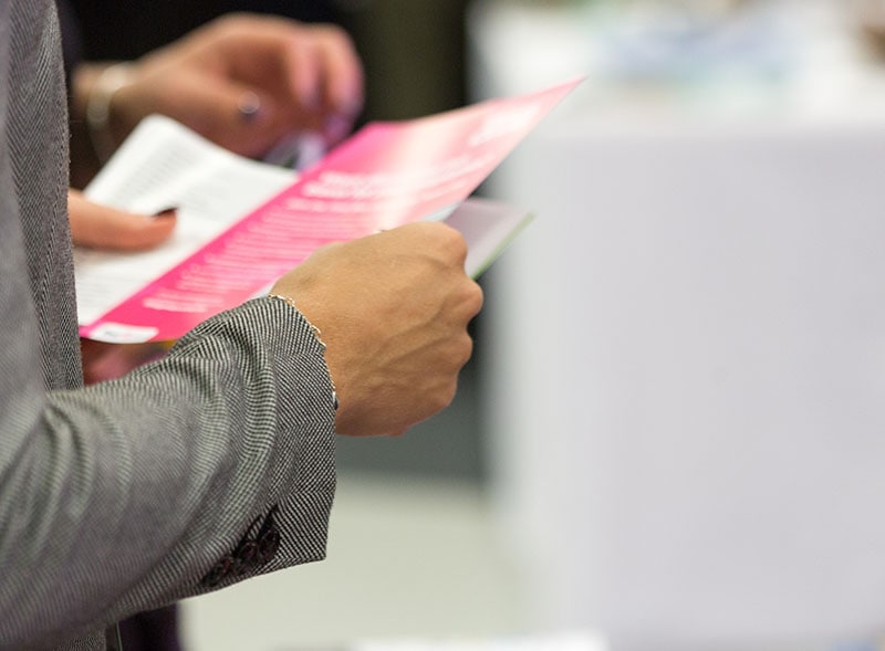female holding a leaflet