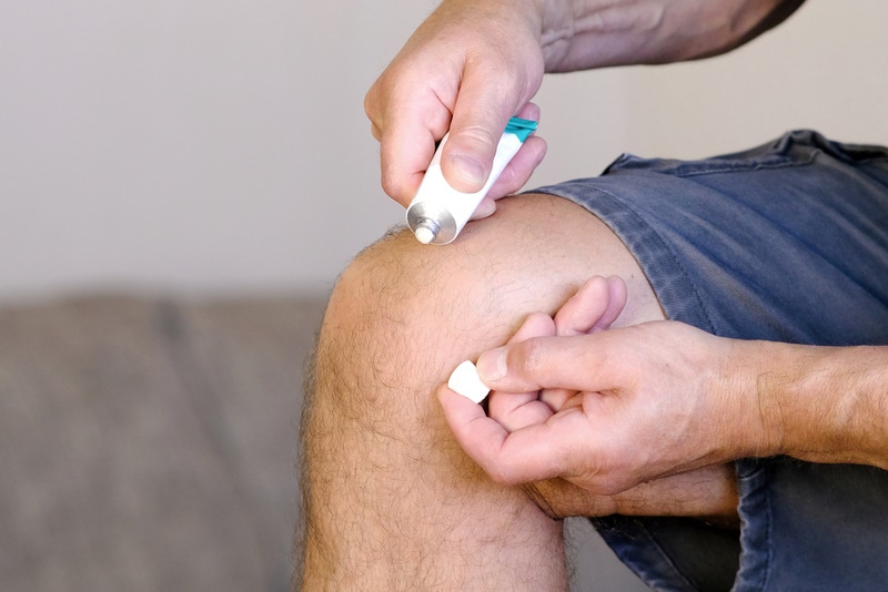 man applying ointment