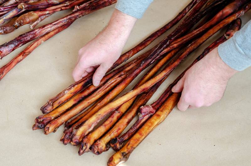 man arranging large sized bully sticks